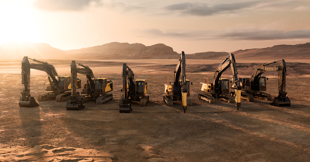 A lineup of seven next-gen Volvo excavators in the desert at sunset.